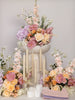 Decorative setup with flowers and candles on a gray background